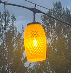 Yellow lattice-weave lantern cover glowing warmly at dusk — Groovy Lanterns